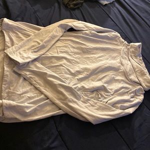 Small blue/grayish sweater.